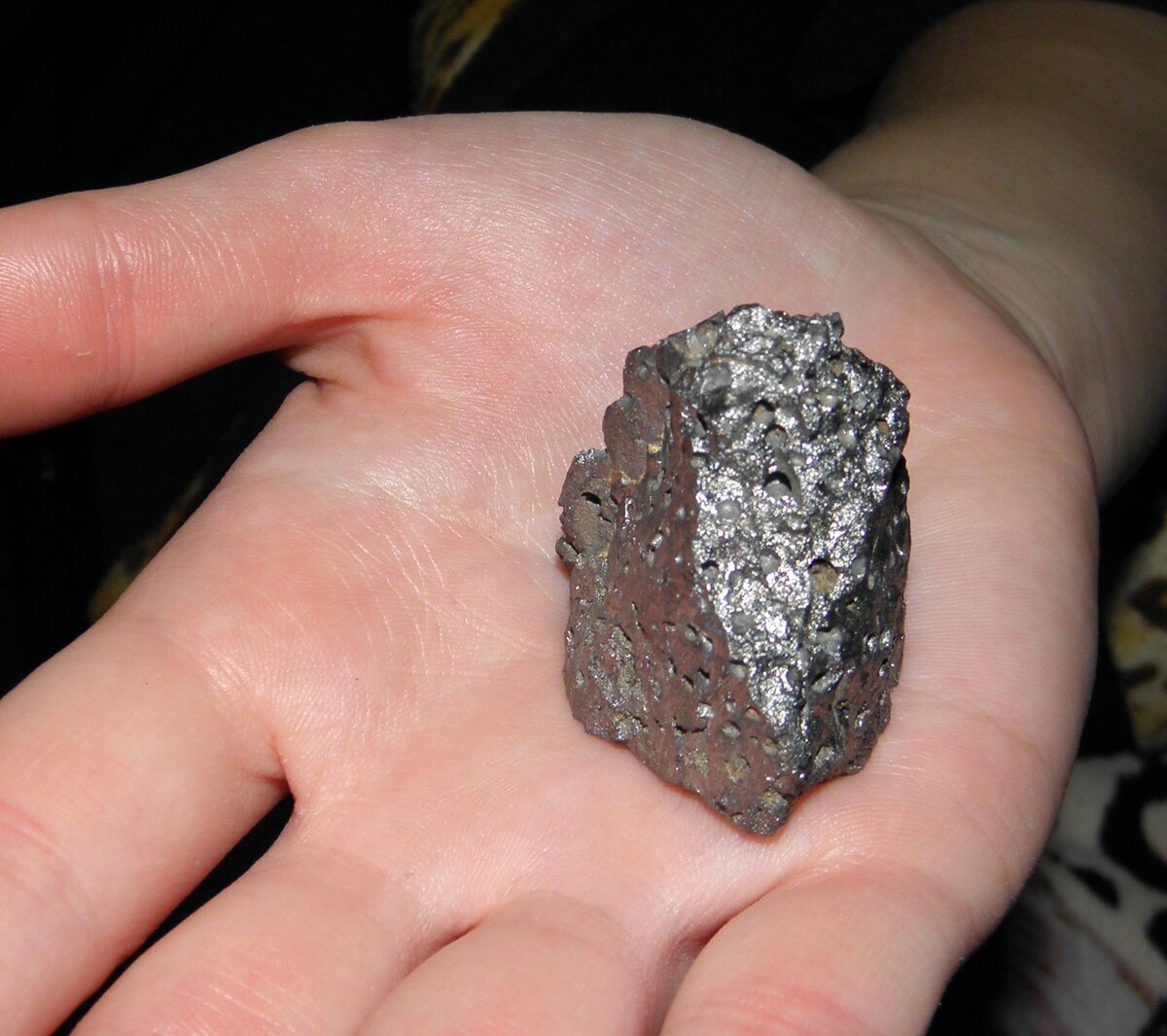 Чуть чуть серебряный. Черный минерал камень магнитится. Галенит самородок. Метеорит магнитится. Серый блестящий камень.